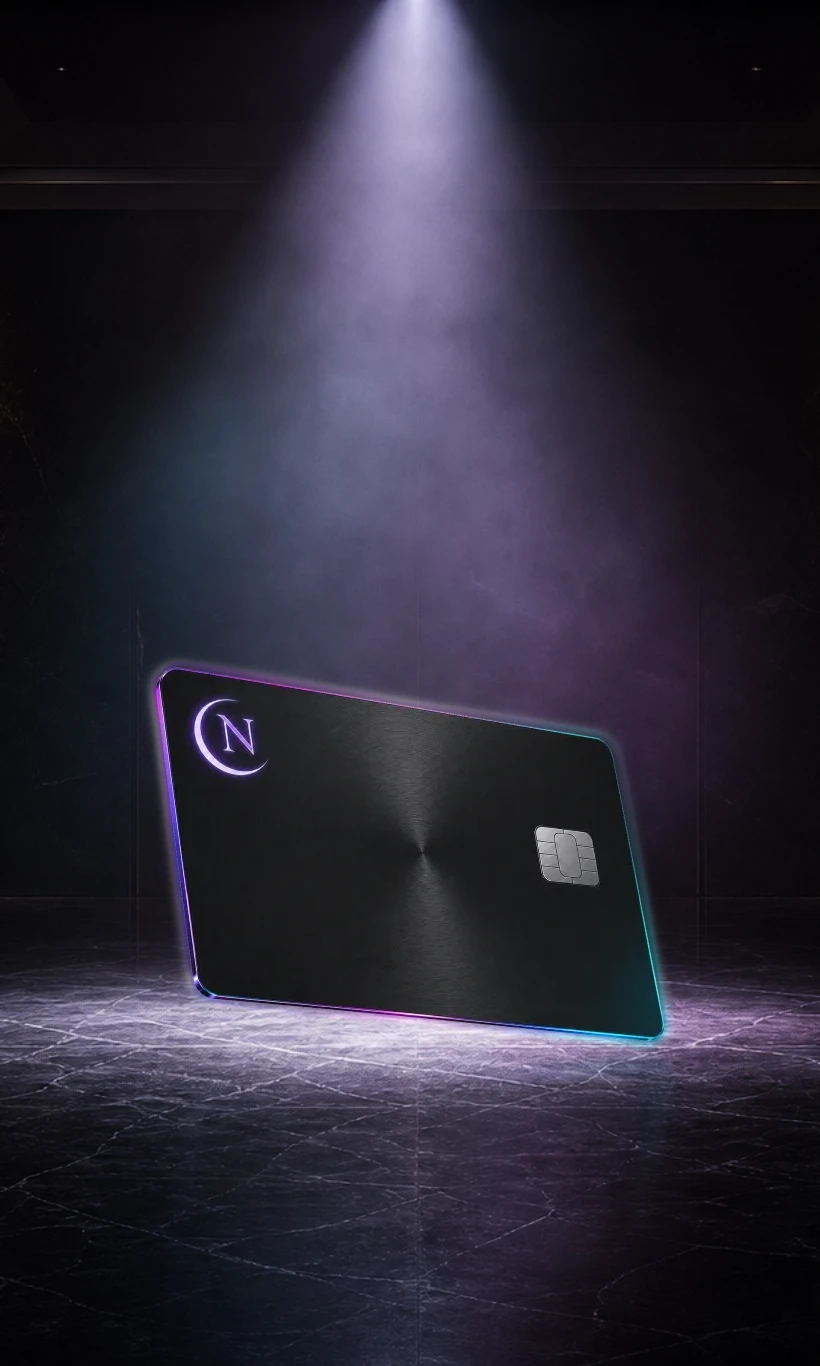 The Nocturne obsidian card standing on dark marble under a single spotlight, its reflection beneath it — waiting
